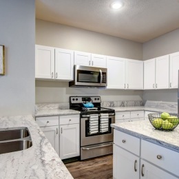 a kitchen with white cabinets