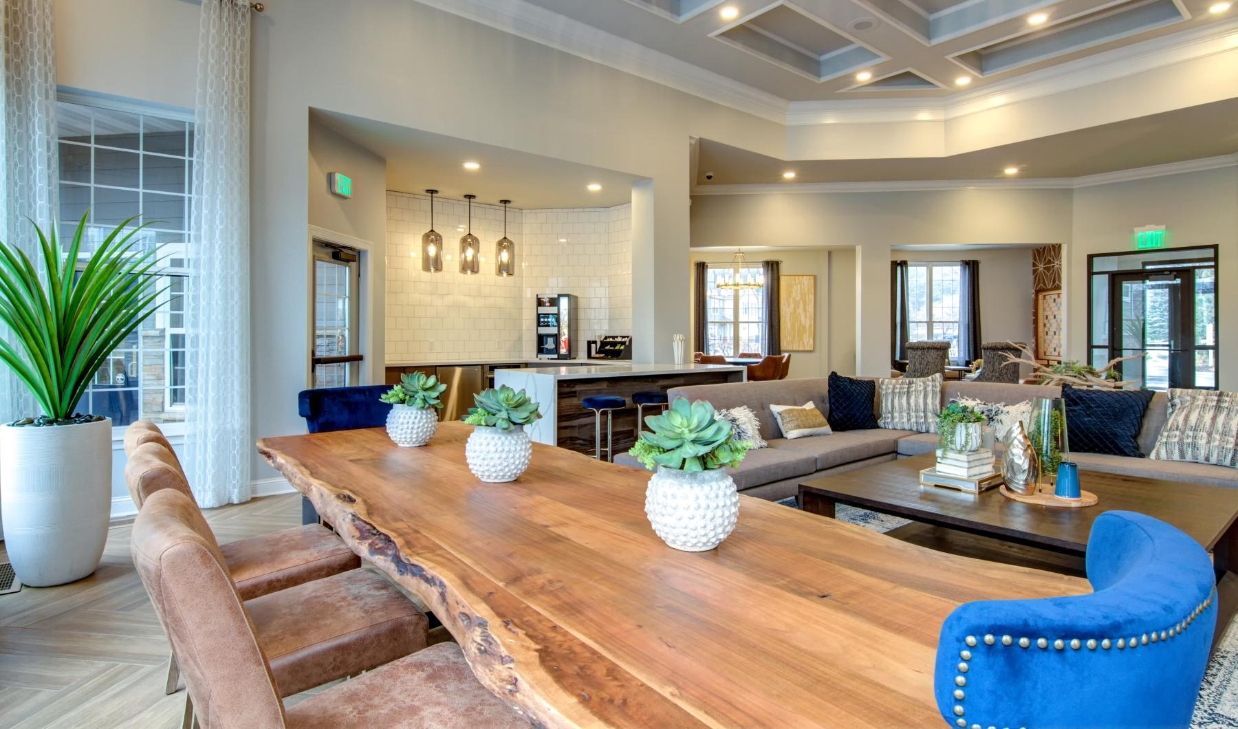 a clubroom with tables, chairs and couches