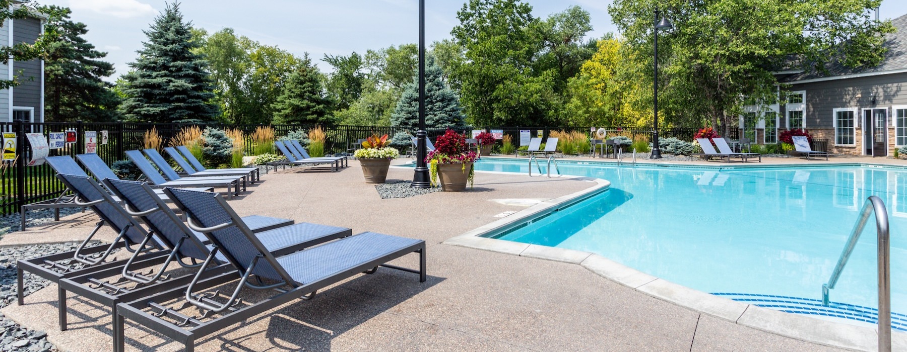 a swimming pool with chairs around it