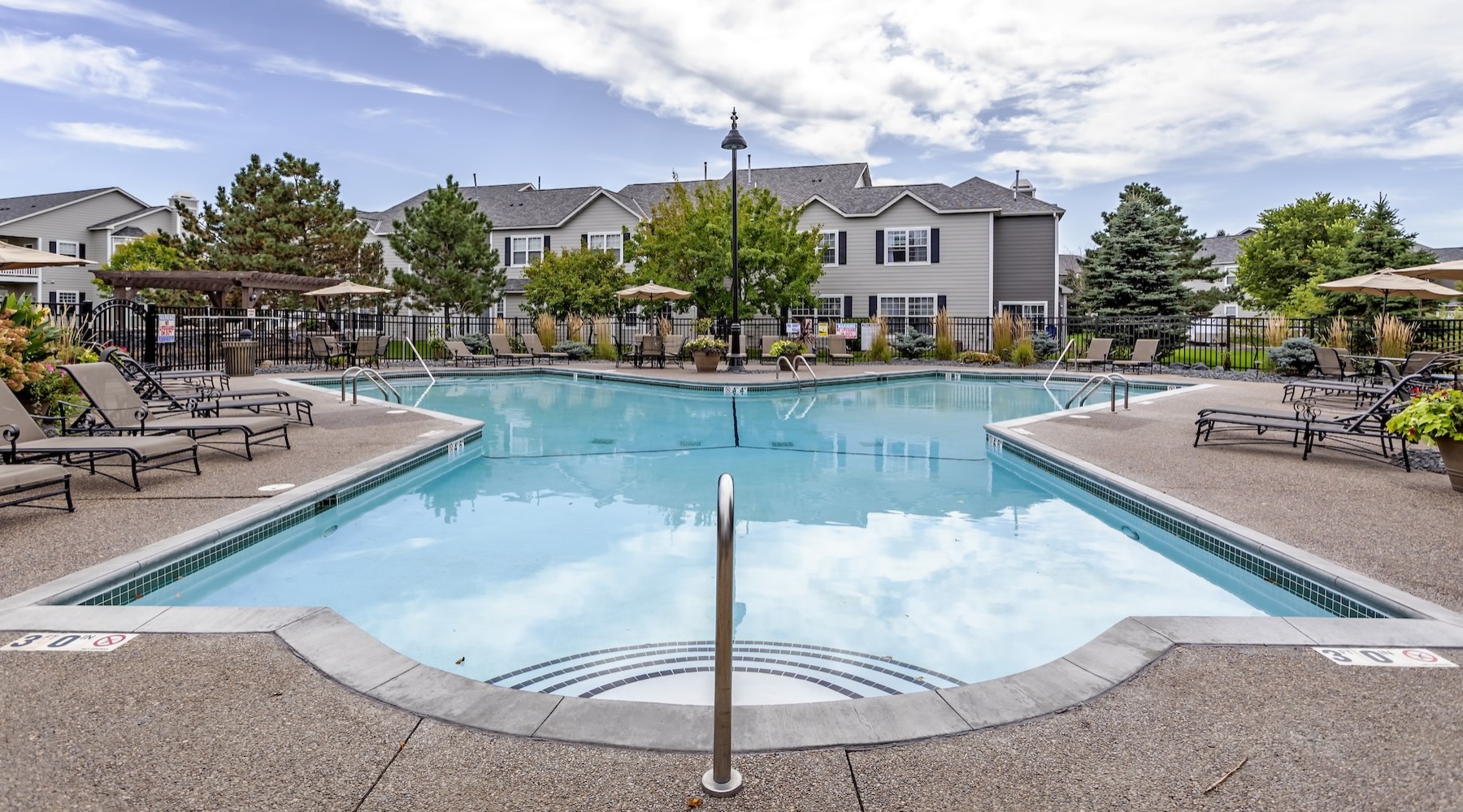 a swimming pool with lounge chairs