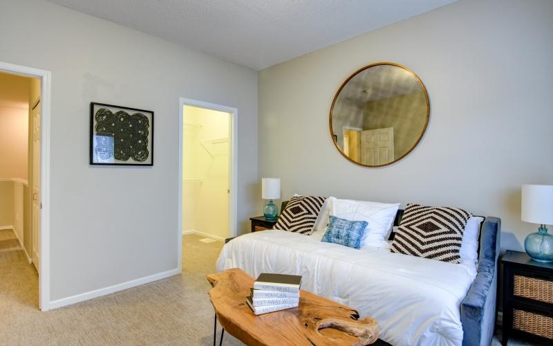 a bedroom with a mirror and a bed
