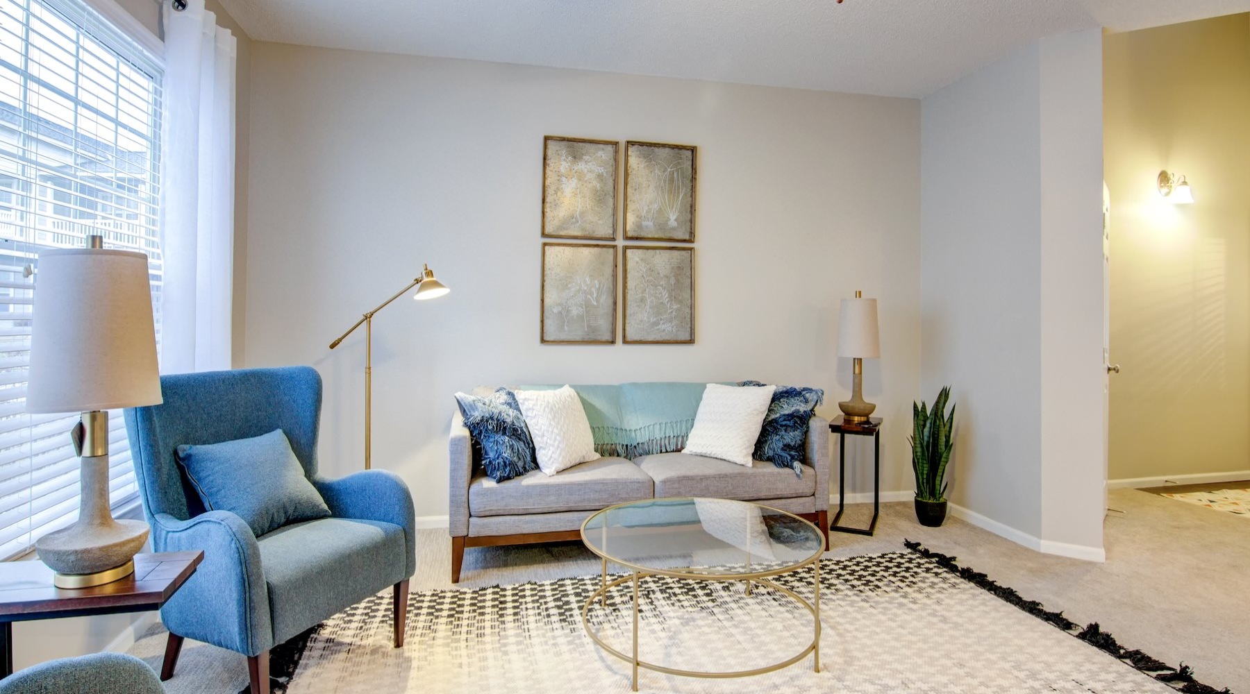 a living room with a couch, chair and coffee table