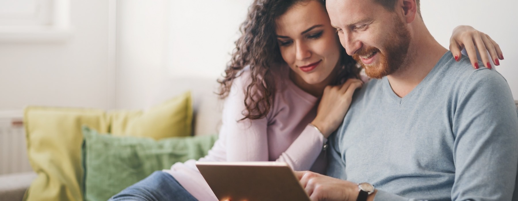 a couple looking at a tablet